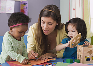 Teacher and two young children